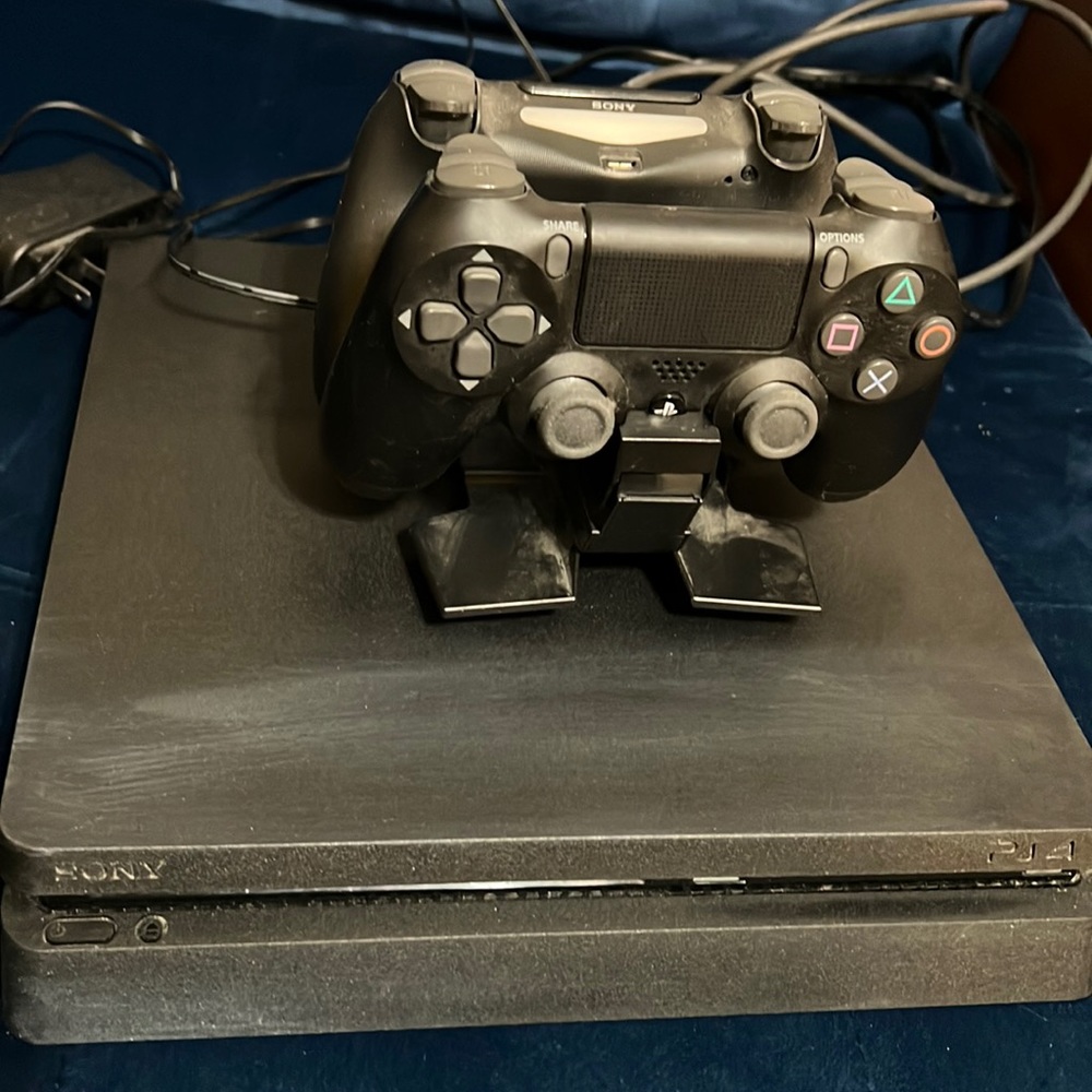 PlayStation 4 w/ 2 remote controls, charging stand, and hdmi cord